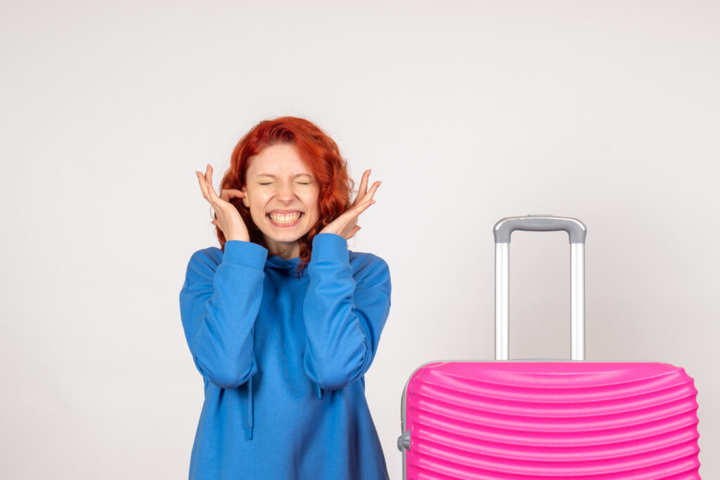 Excited Female Traveler With Pink Suitcase 1024x683